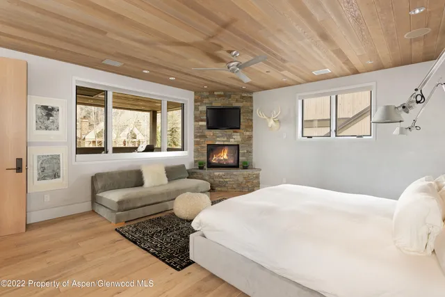 a bedroom with furniture and a flat screen tv