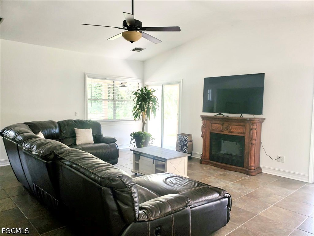 740 19th Street Southwest Naples, FL 34117 - Photo 13 of 35 a living room with furniture a flat screen tv and a fireplace