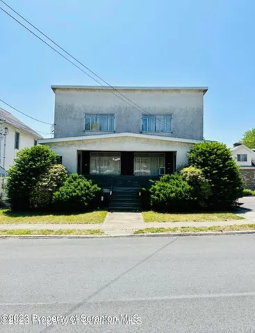 a view of house with swimming pool and yard