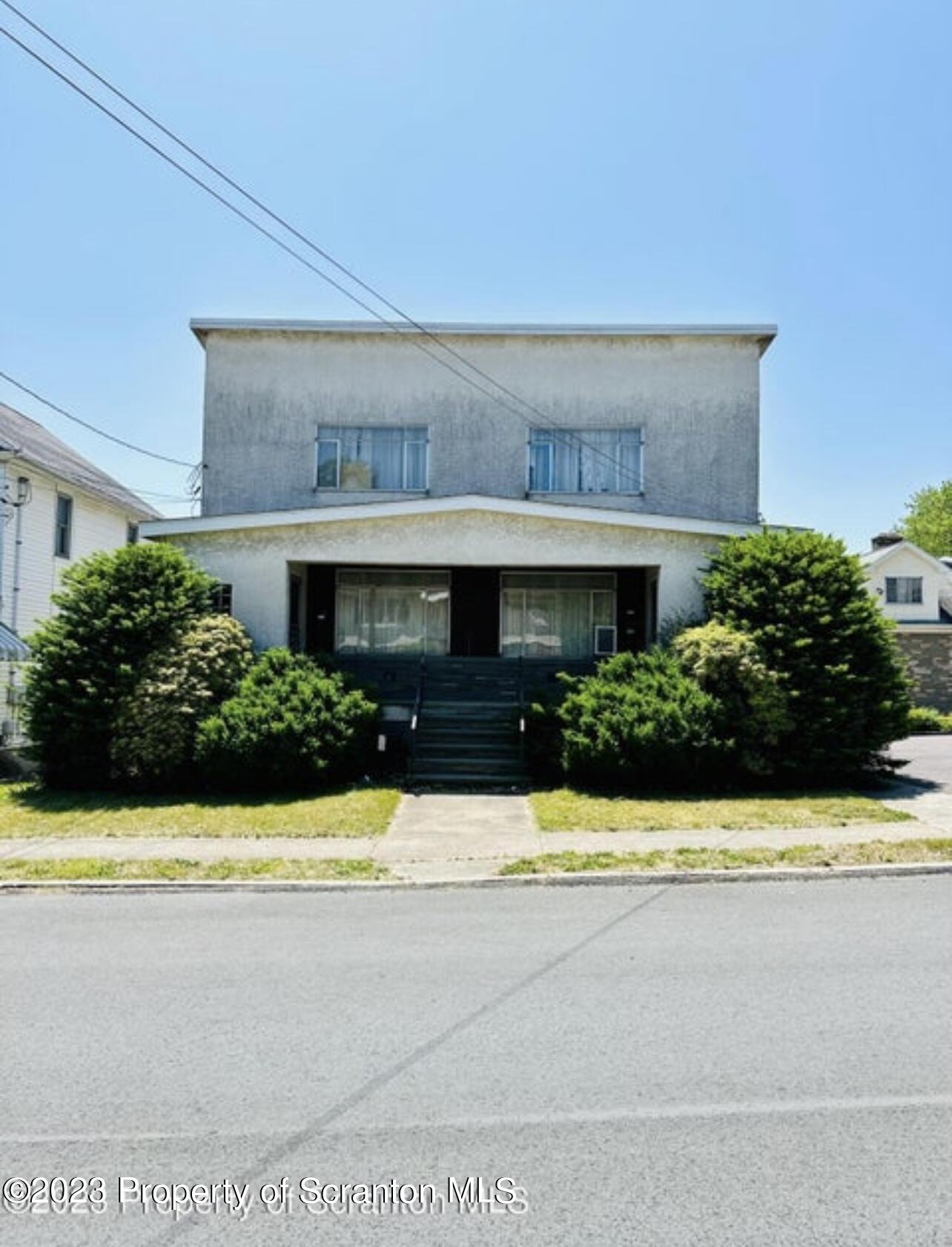 a view of house with swimming pool and yard