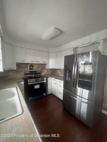 a kitchen with granite countertop stainless steel appliances and counter space