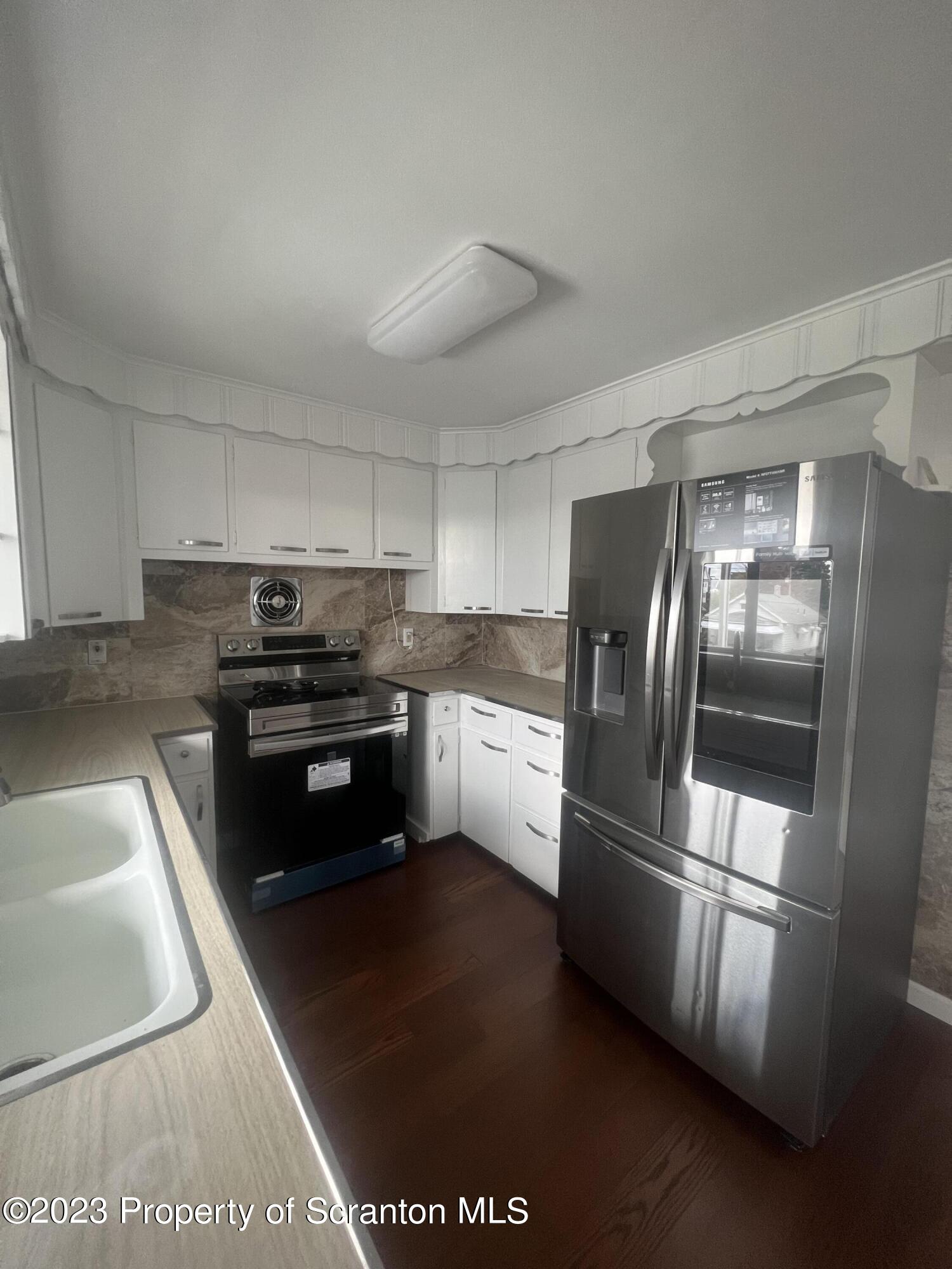 1151 Amherst Street Scranton, PA 18504 - Photo 6 of 11 a kitchen with granite countertop stainless steel appliances and counter space