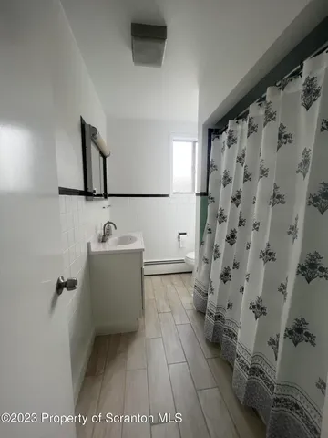 a bathroom with a bathtub and shower