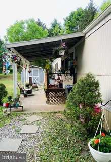 a view of a patio with table and chairs potted plants with wooden fence