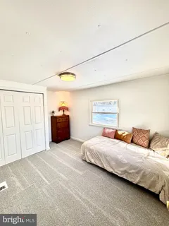 a bedroom with a bed and dresser