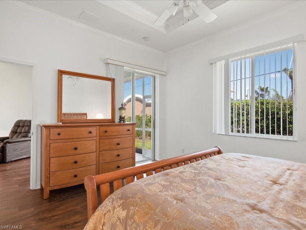 8679 Spring Mountain Way Fort Myers, FL 33908 - Photo 12 of 21 a bedroom with a bed and a dresser