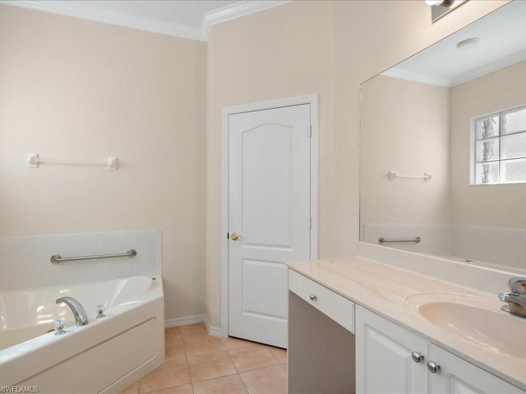 8679 Spring Mountain Way Fort Myers, FL 33908 - Photo 13 of 21 a bathroom with a tub sink and mirror