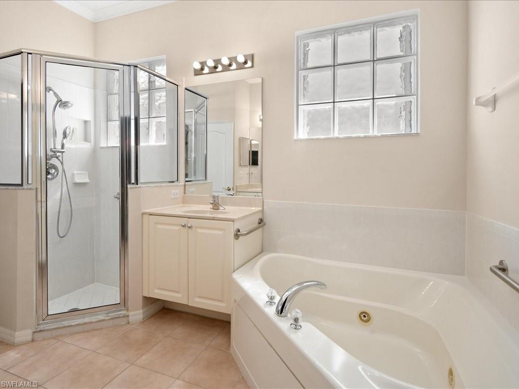 8679 Spring Mountain Way Fort Myers, FL 33908 - Photo 14 of 21 a bathroom with a tub a sink and a shower