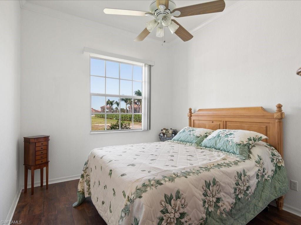 8679 Spring Mountain Way Fort Myers, FL 33908 - Photo 15 of 21 a bedroom with a bed and a chandelier