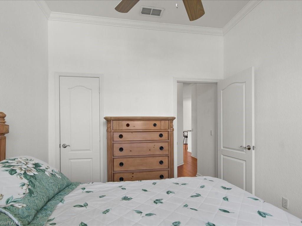 8679 Spring Mountain Way Fort Myers, FL 33908 - Photo 16 of 21 a bedroom with a bed and a dresser