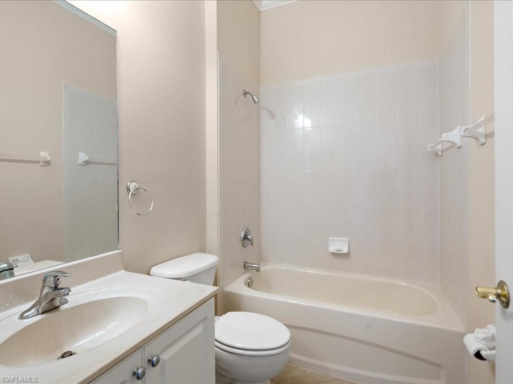 8679 Spring Mountain Way Fort Myers, FL 33908 - Photo 17 of 21 a bathroom with a bathtub shower sink mirror vanity and a toilet