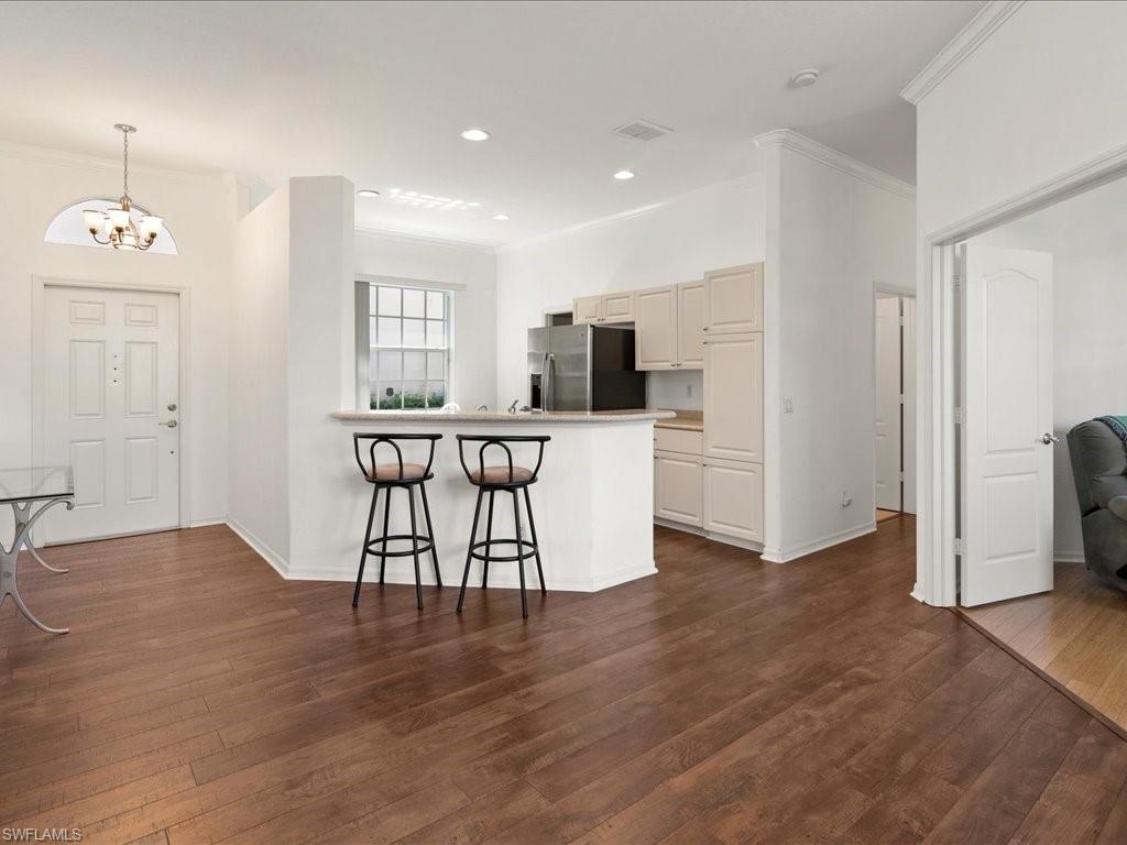 8679 Spring Mountain Way Fort Myers, FL 33908 - Photo 5 of 21 a view of a kitchen with wooden floor and electronic appliances