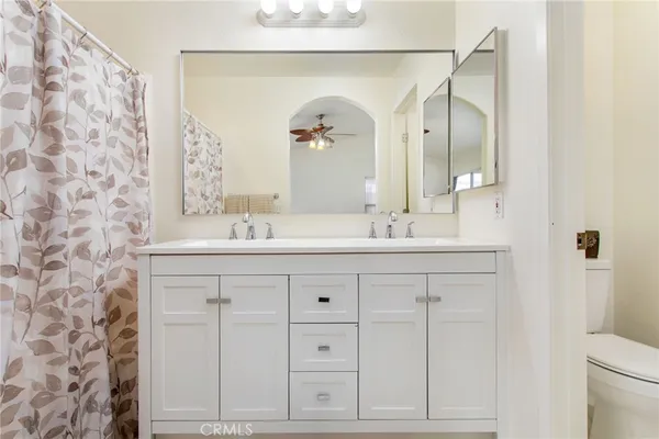 a bathroom with a sink vanity and a mirror