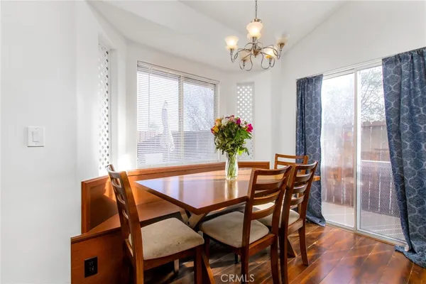a view of a dining room with furniture and a chandelier