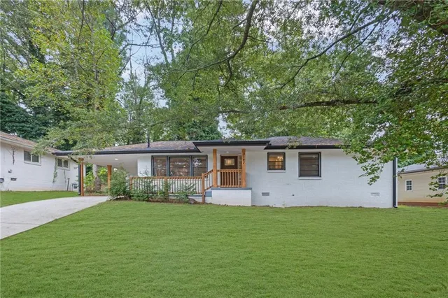 a front view of house with yard and green space