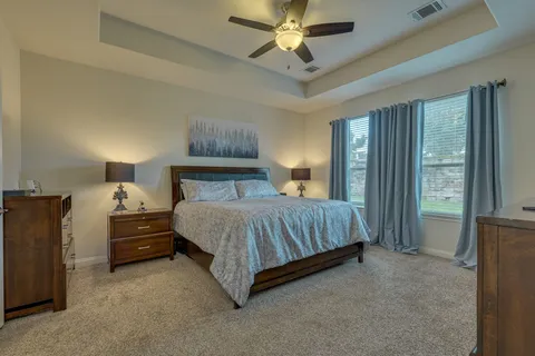 a bedroom with a bed and a chandelier