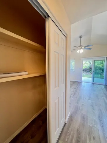 a view of hallway with wooden floor