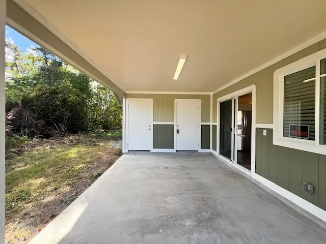 a view of a big room with yard and balcony