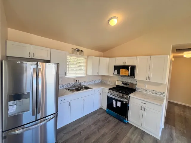 a kitchen with stainless steel appliances a refrigerator stove and sink