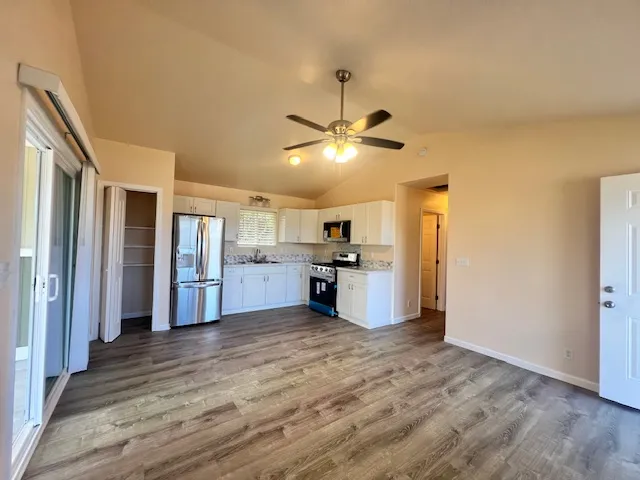 a view of a kitchen with a sink and cabinet area