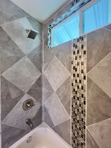 view of a bathroom with a shower and a sink