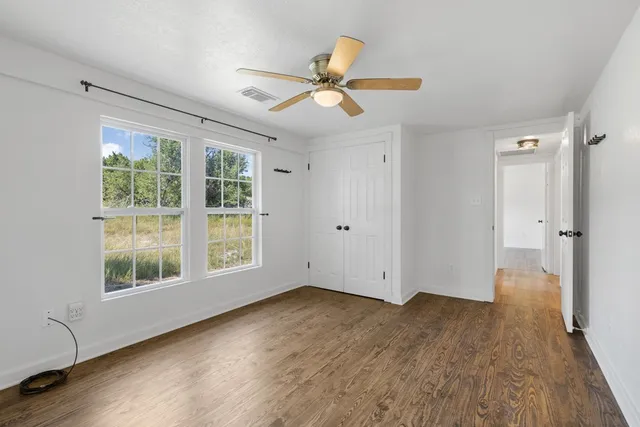 a bedroom with a bed and glass window