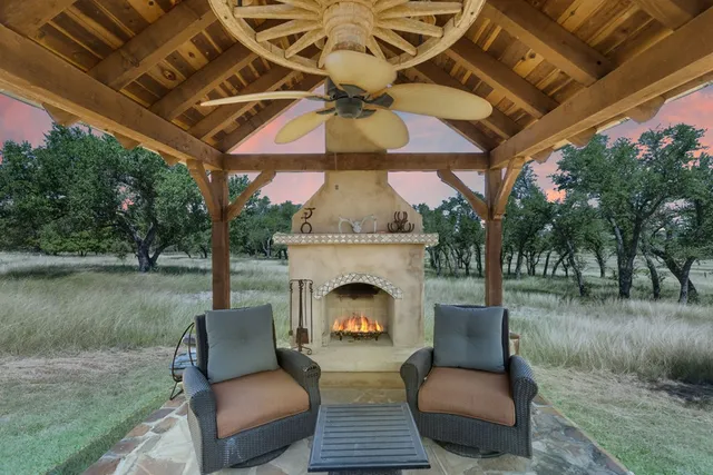 a view of a patio with a table and chairs under an umbrella