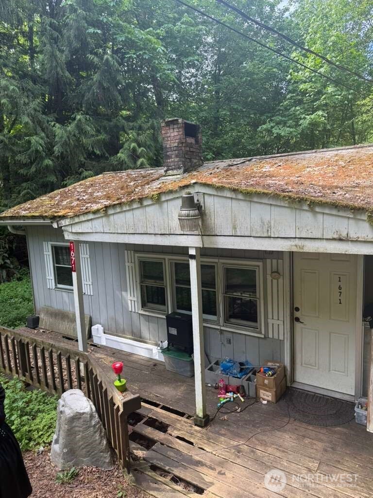 1671 Northeast Mission Creek Road Belfair, WA 98528 - Photo 1 of 31 a view of a house with a patio and wooden fence