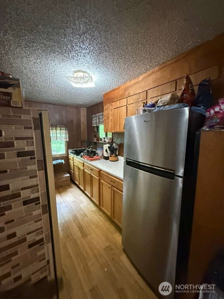 1671 Northeast Mission Creek Road Belfair, WA 98528 - Photo 30 of 31 a kitchen with a refrigerator and a sink