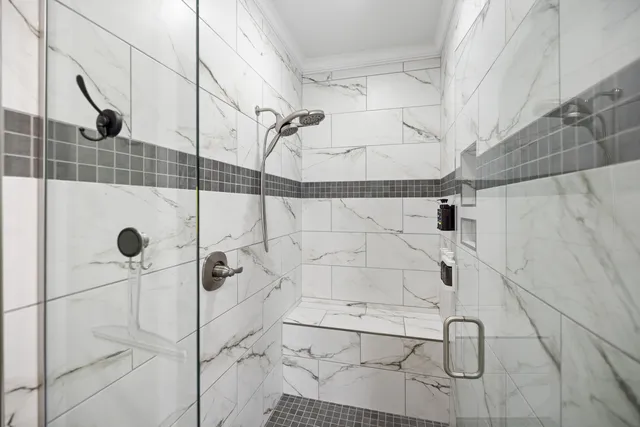 a white bath tub sitting in a bathroom next to a white tub