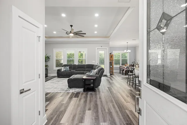 a living room with furniture and a glass door