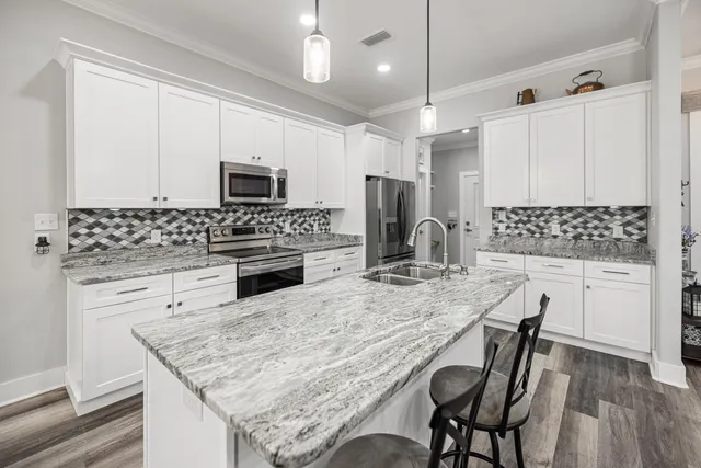 a living room with furniture and a flat screen tv with wooden floor