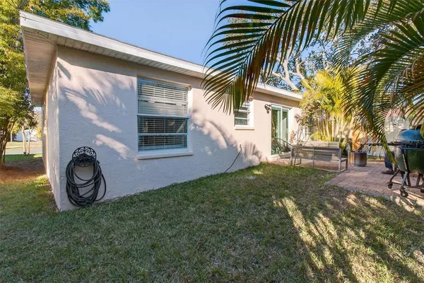 a front view of a house with garden and parking