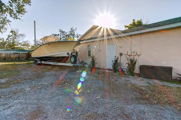 a backyard of a house with table and chairs