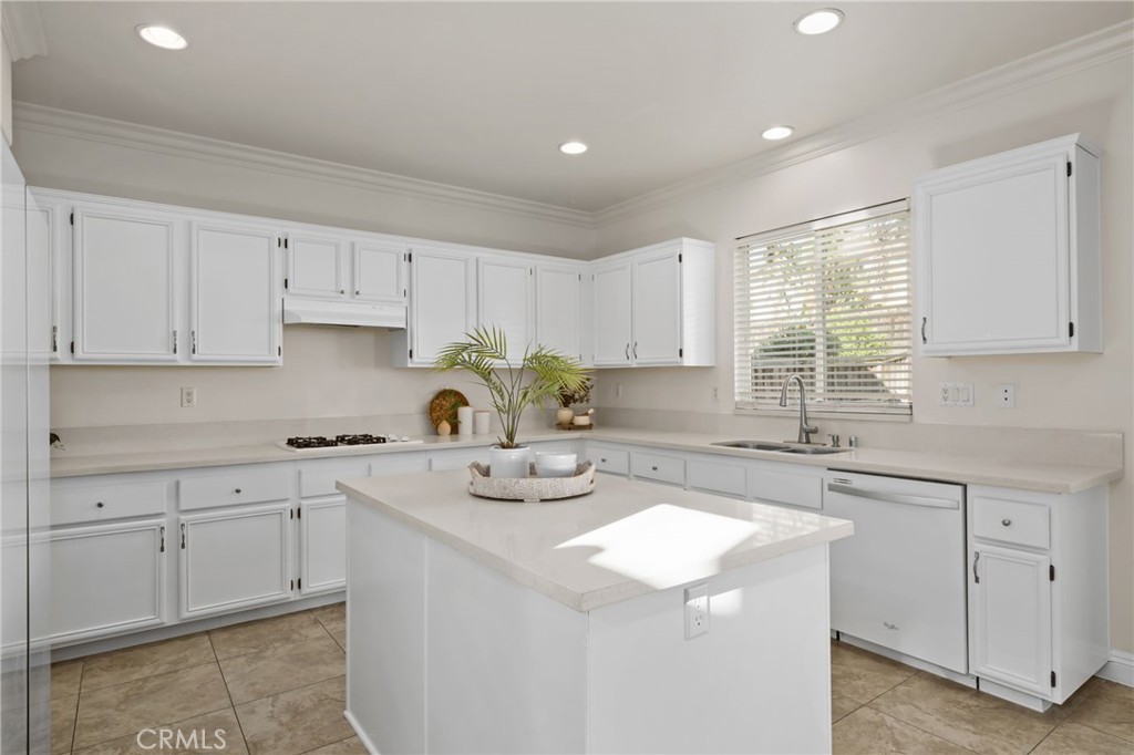 6124 Risingstar Drive Eastvale, CA 92880 - Photo 11 of 37 a kitchen with sink stove and cabinets