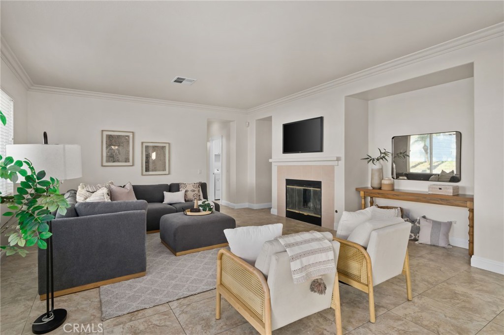 6124 Risingstar Drive Eastvale, CA 92880 - Photo 14 of 37 a living room with furniture a fireplace and a flat screen tv