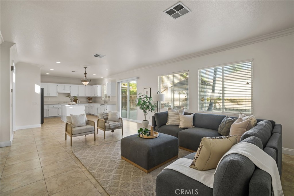6124 Risingstar Drive Eastvale, CA 92880 - Photo 16 of 37 a living room with furniture and a large window