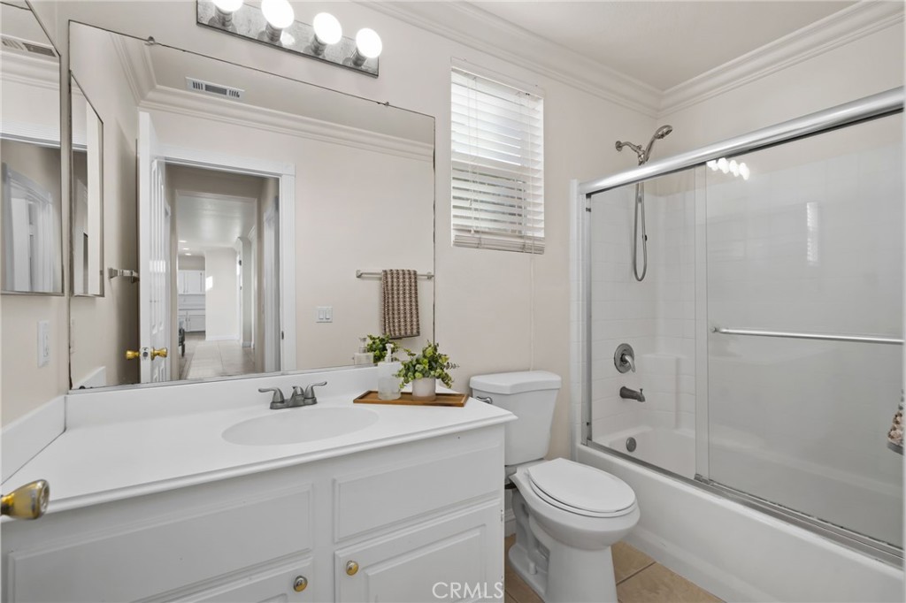 6124 Risingstar Drive Eastvale, CA 92880 - Photo 19 of 37 a bathroom with a sink toilet and shower