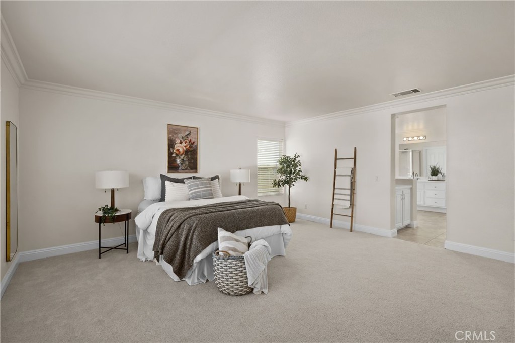6124 Risingstar Drive Eastvale, CA 92880 - Photo 25 of 37 a spacious bedroom with a bed and a cabinets