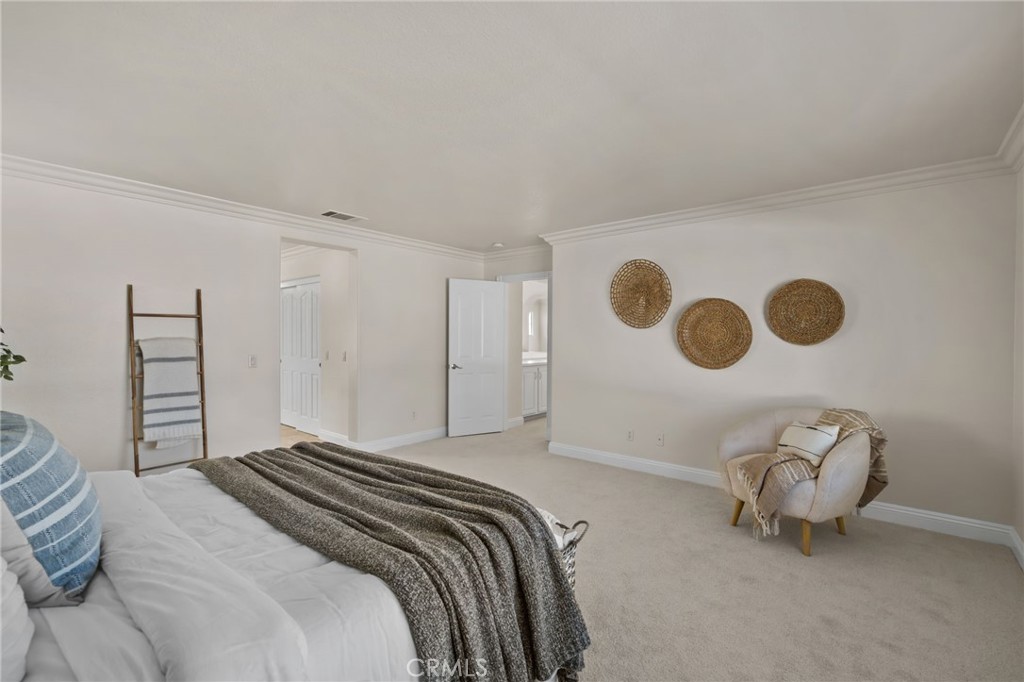6124 Risingstar Drive Eastvale, CA 92880 - Photo 26 of 37 a bedroom with a bed and a lamp