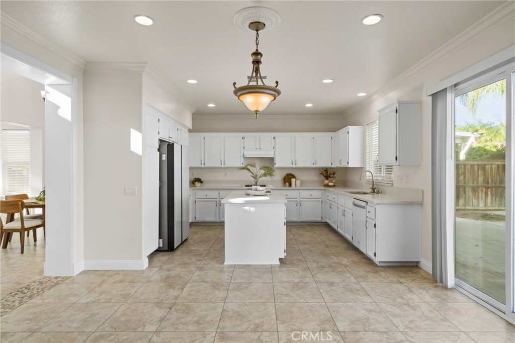 6124 Risingstar Drive Eastvale, CA 92880 - Photo 9 of 37 a view of a kitchen with refrigerator and microwave