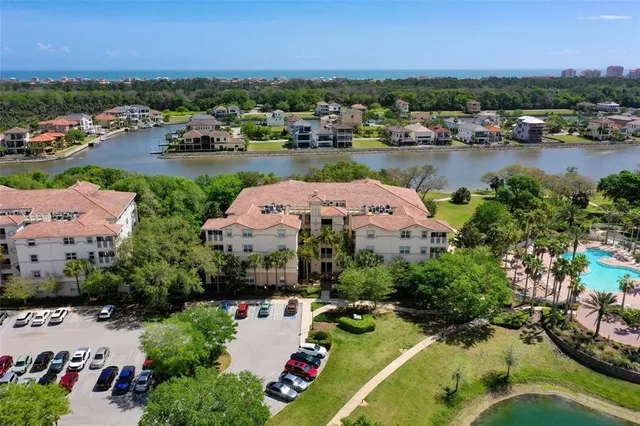 an aerial view of residential houses with outdoor space and swimming pool