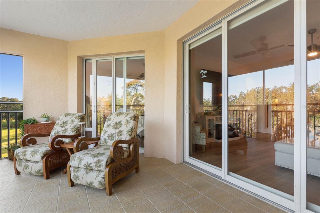 55 Riverview Bend South, Unit 2033 Palm Coast, FL 32137 - Photo 15 of 75 a living room with furniture and a floor to ceiling window