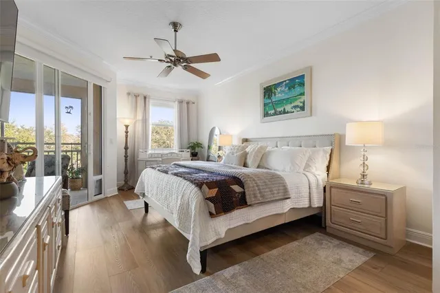 a bedroom with a large bed and a chandelier