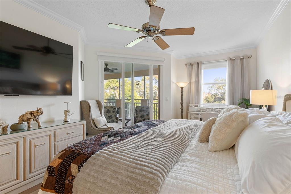 55 Riverview Bend South, Unit 2033 Palm Coast, FL 32137 - Photo 25 of 75 a bedroom with a bed and a flat screen tv