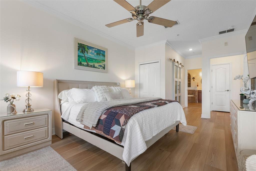 55 Riverview Bend South, Unit 2033 Palm Coast, FL 32137 - Photo 27 of 75 a spacious bedroom with a bed and a chandelier