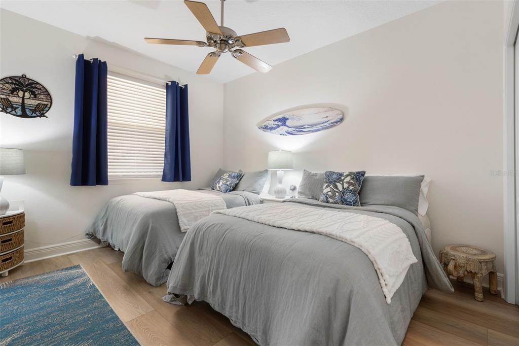 55 Riverview Bend South, Unit 2033 Palm Coast, FL 32137 - Photo 32 of 75 a bedroom with bed and a chandelier
