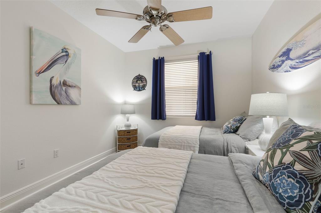 55 Riverview Bend South, Unit 2033 Palm Coast, FL 32137 - Photo 34 of 75 a bedroom with a large bed and a chandelier