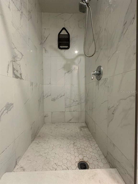 322 North Wekiwa Springs Road, Unit B Apopka, FL 32703 - Photo 11 of 15 a bathroom with a shower