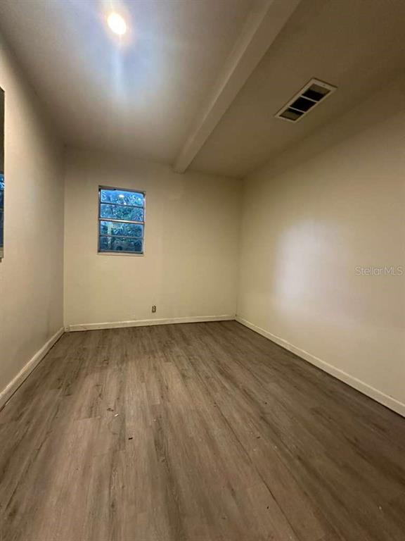322 North Wekiwa Springs Road, Unit B Apopka, FL 32703 - Photo 13 of 15 a view of a room with wooden floor and window